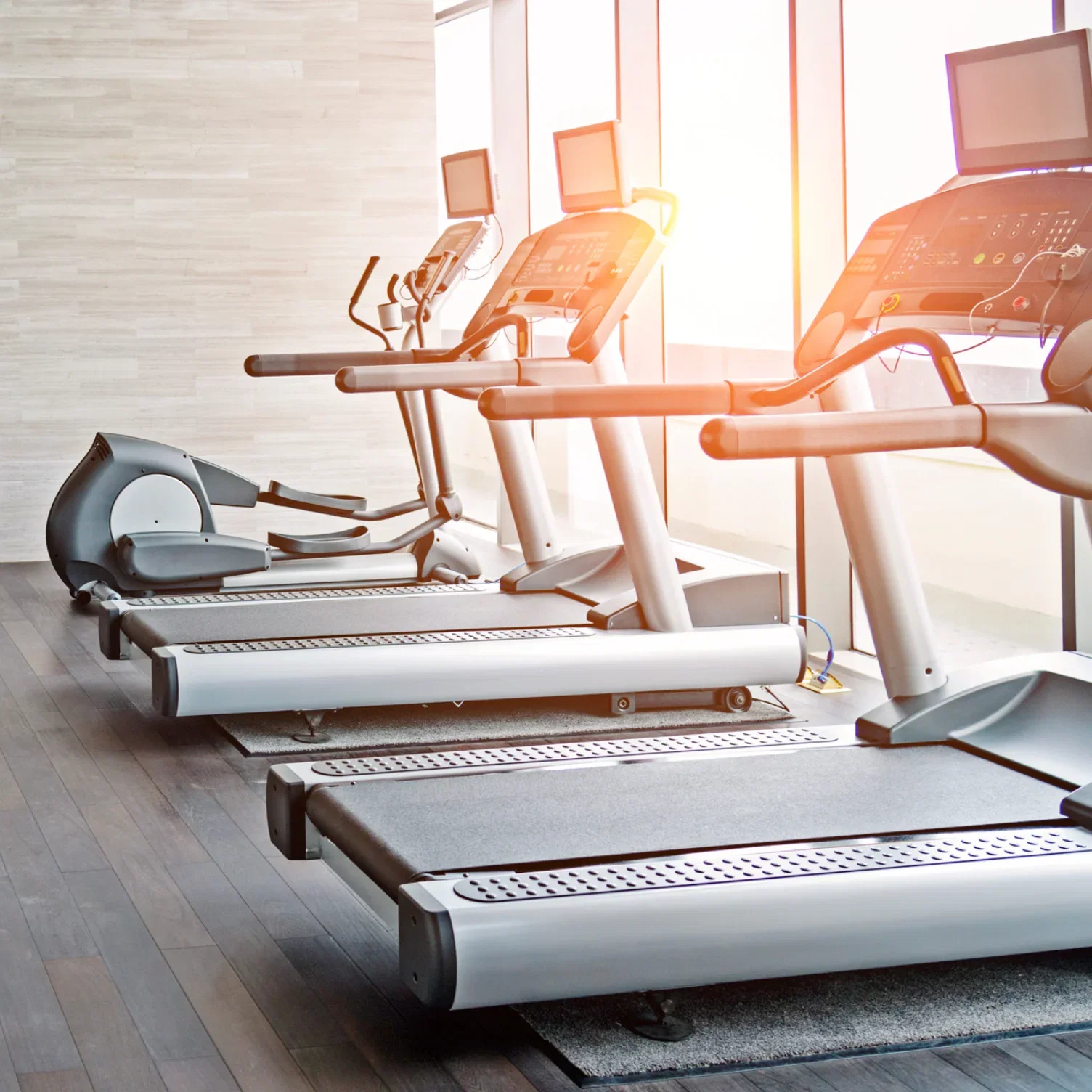 Concept fitness room next to the large windows with natural light